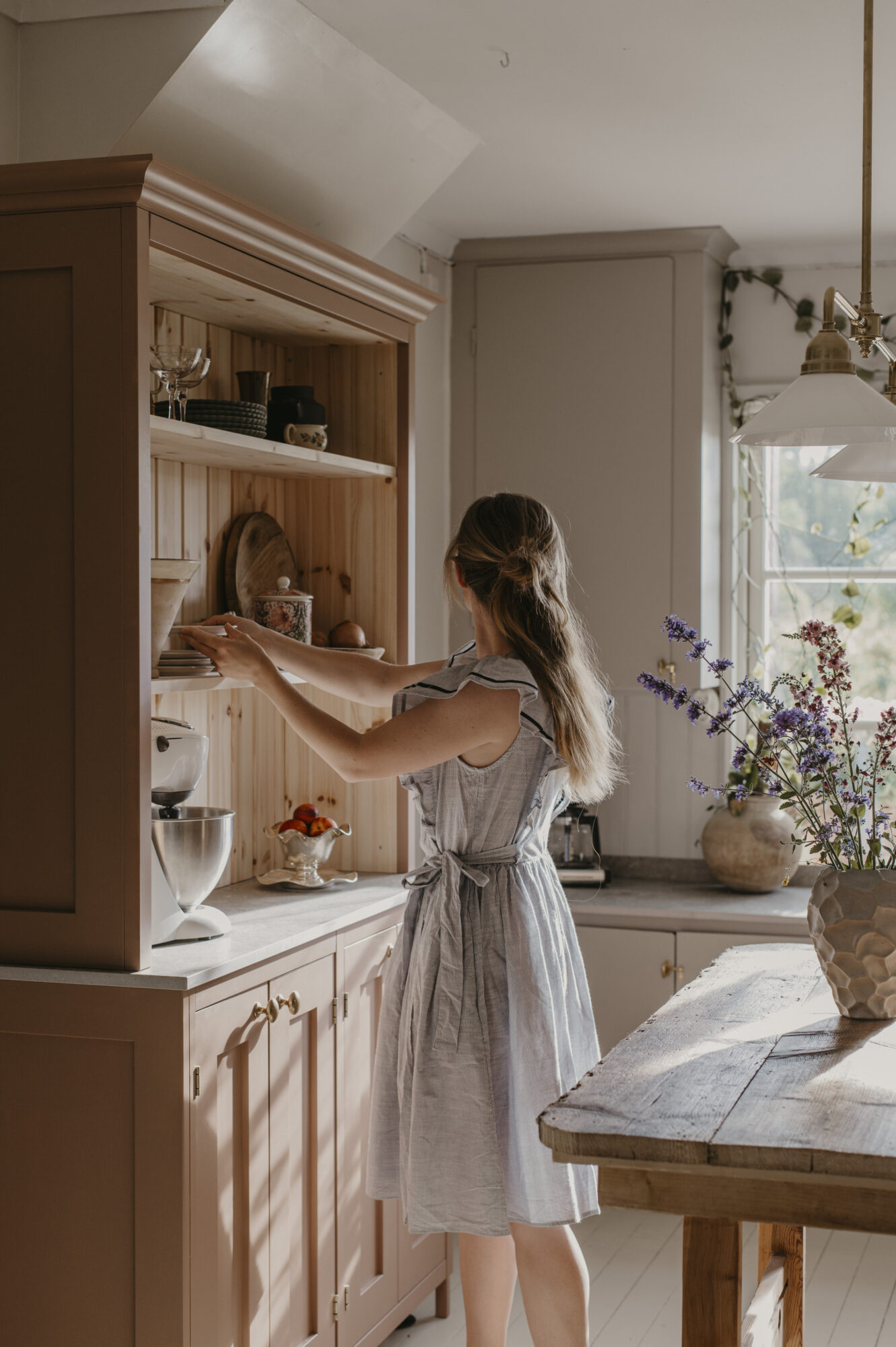 Person vid diskbänk i ljust kök